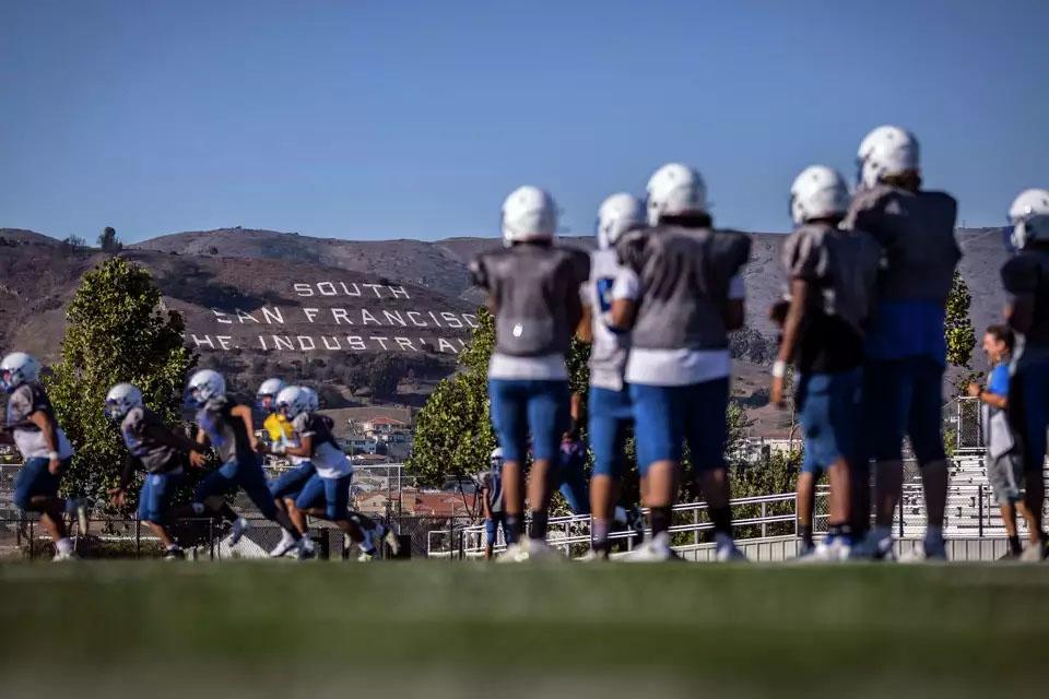 South San Francisco High varsity players (in gray jerseys) watch JV players do drills during a combined football practice. (Photos by Carlos Avila Gonzalez / The Chronicle)